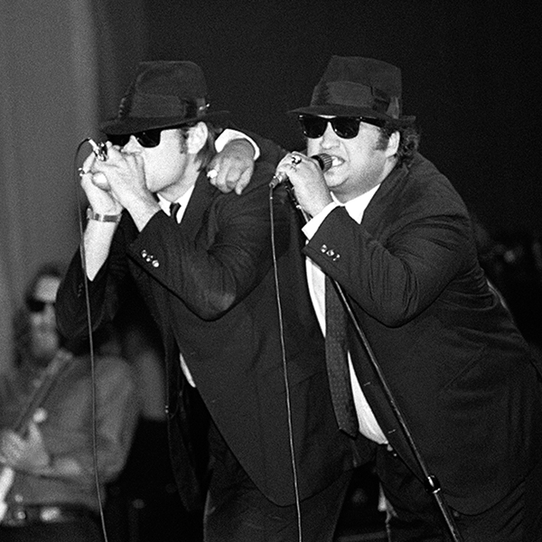 Dan Aykroyd and John Belushi with Steve Cropper in back performing with The Blues Brothers in 1980.
